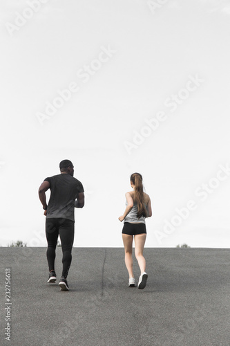 happy young couple afro-american man and european woman running together. A loving couple is run, engaged in sports, family values