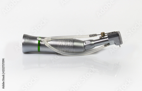 Low speed handpiece for dental implantology on mirror background