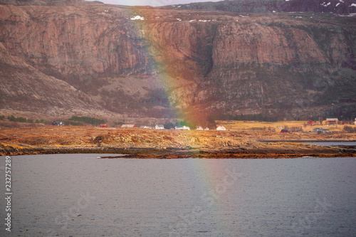 Rainbow above little Norway village alone the coast
