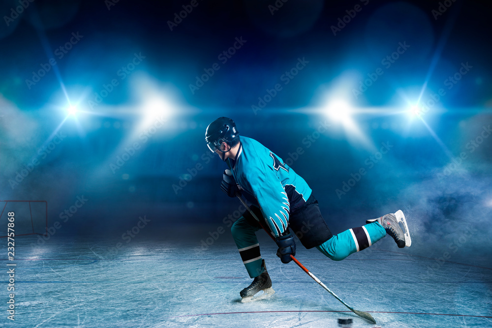 One hockey player skating on ice arena