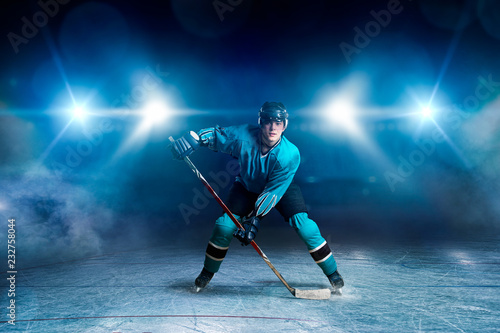 Hockey player with stick on ice, game concept