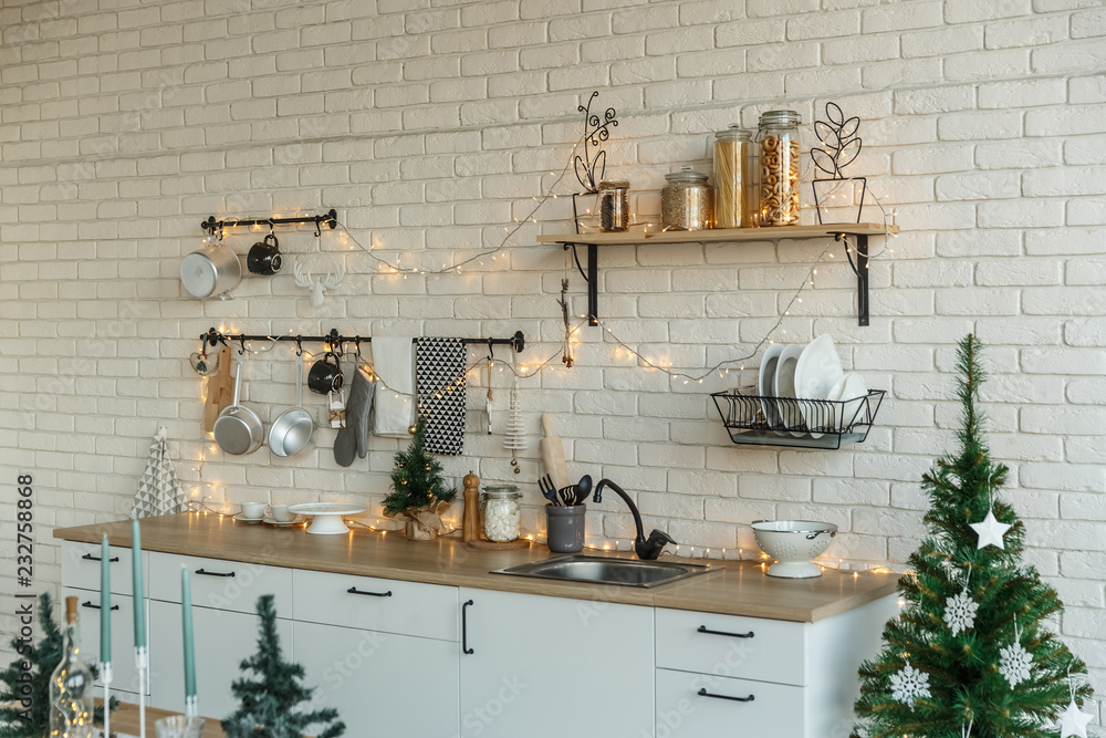 Interior light kitchen with christmas decor and tree Interior light kitchen with christmas decor and tree