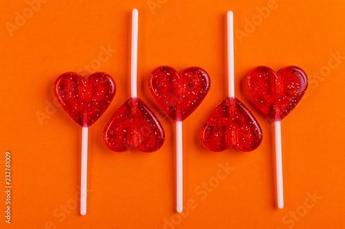 Five red sweet tasty lollipops in shape of heart