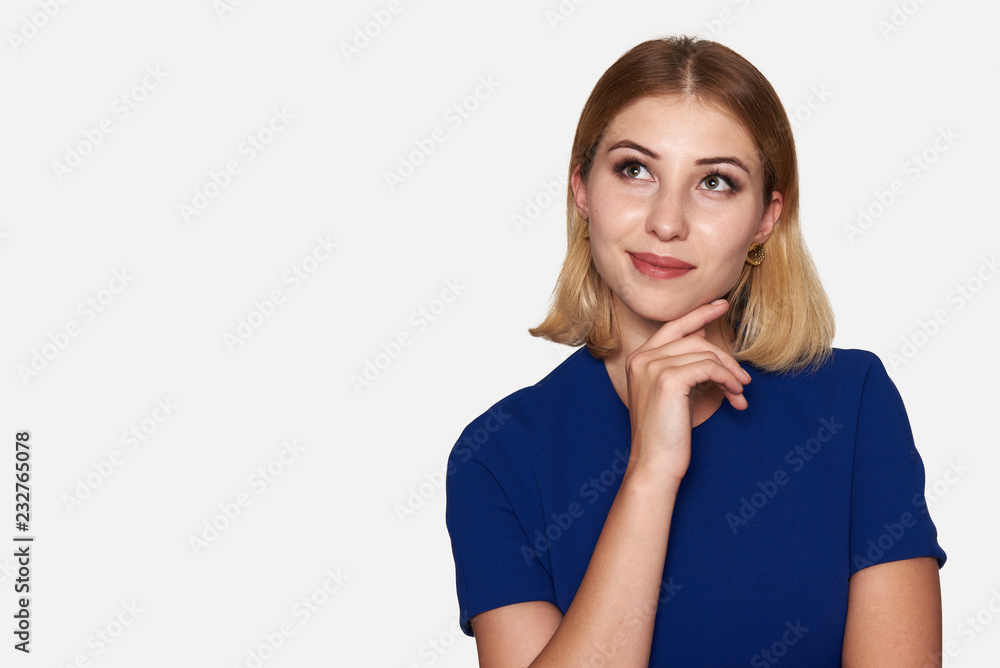 Smiling woman looking up. Isolated on grey Smiling woman looking up. Isolated on grey