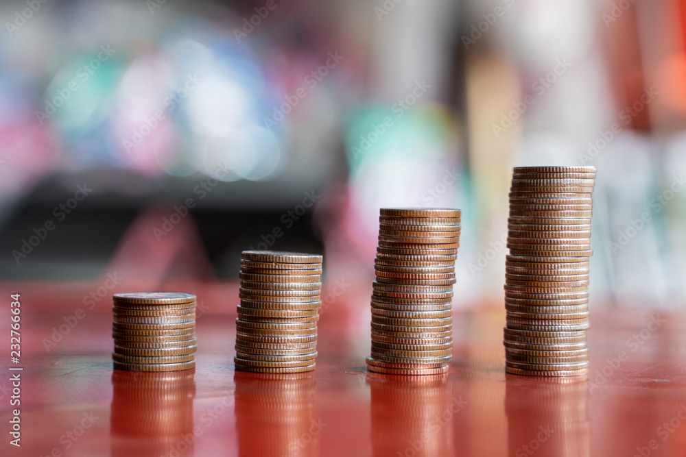 step of coins stacks with sandglass or hourglass, saving and investment or family planning concept, motion blured background. step of coins stacks with sandglass or hourglass, saving and investment or family planning concept, motion blured background.