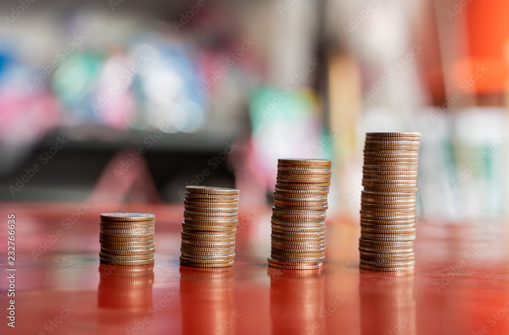 step of coins stacks with sandglass or hourglass, saving and investment or family planning concept, motion blured background. step of coins stacks with sandglass or hourglass, saving and investment or family planning concept, motion blured background.