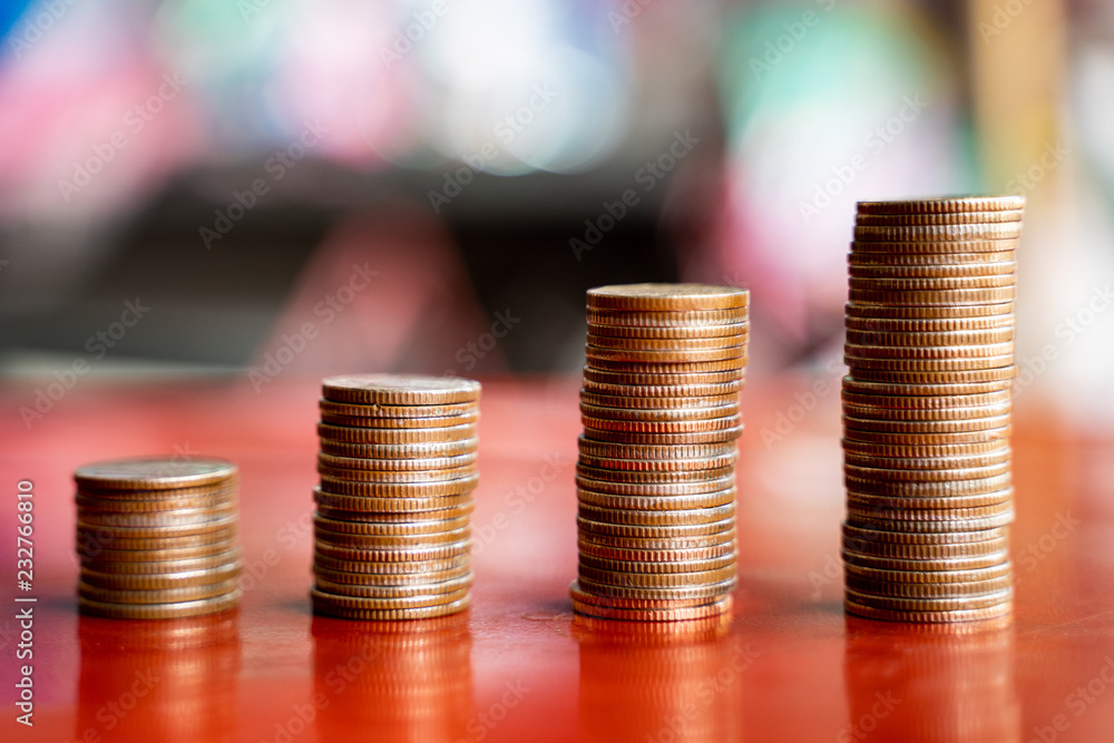 step of coins stacks with sandglass or hourglass, saving and investment or family planning concept, motion blured background. step of coins stacks with sandglass or hourglass, saving and investment or family planning concept, motion blured background.