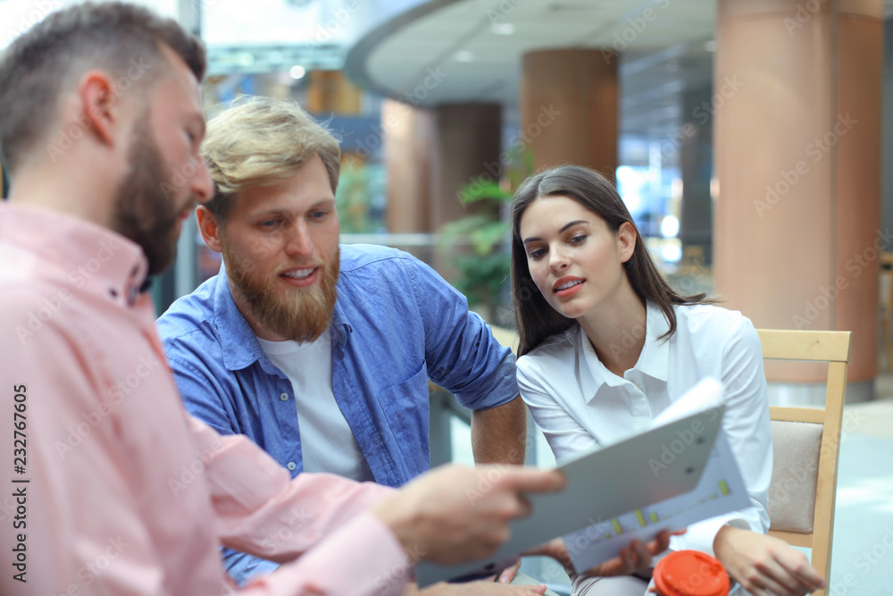 Young colleagues in smart casual wear working while spending time in the office. Young colleagues in smart casual wear working while spending time in the office.