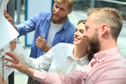 Group of young business people and designers in smart casual wear. They working on new project.