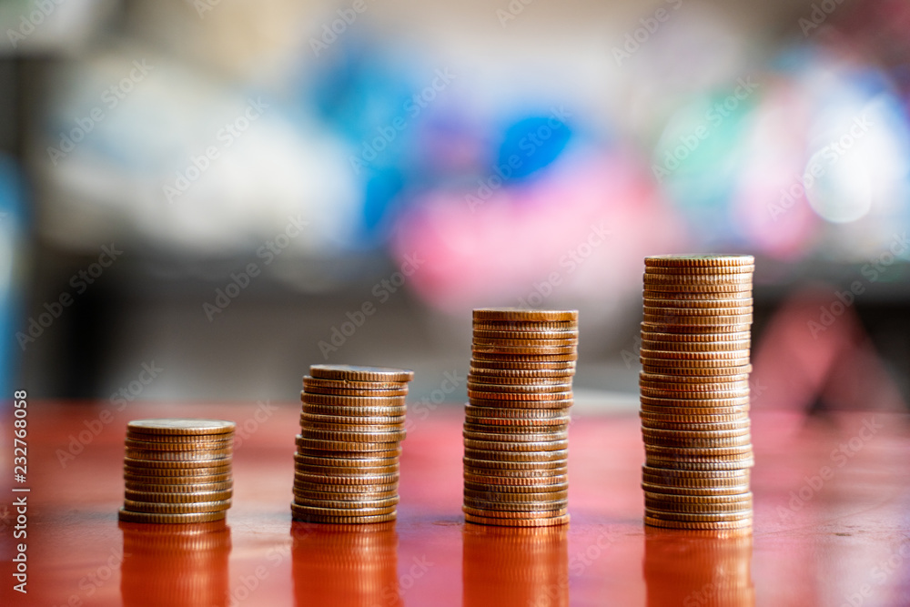 step of coins stacks, saving and investment or family planning concept, motion blured background. step of coins stacks, saving and investment or family planning concept, motion blured background.