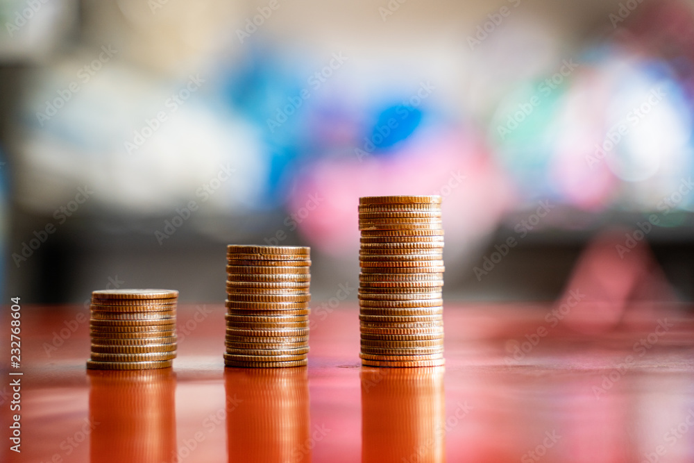 step of coins stacks, saving and investment or family planning concept, motion blured background.