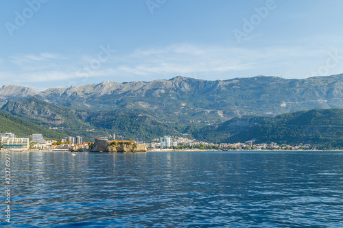 View of the mountains and the resort town of Budva and its fortress in Montenegro from the sea