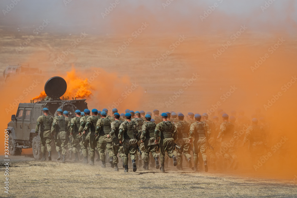 custom made wallpaper toronto digitalKADAMOVSKIY TRAINING GROUND, ROSTOV REGION, RUSSIA, 26 AUGUST 2018: Detachment of Russian paratroopers runs for an armored car across the field in protective orange smoke