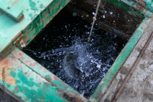 The bucket on the rope fell into the well, creating a lot of splashing