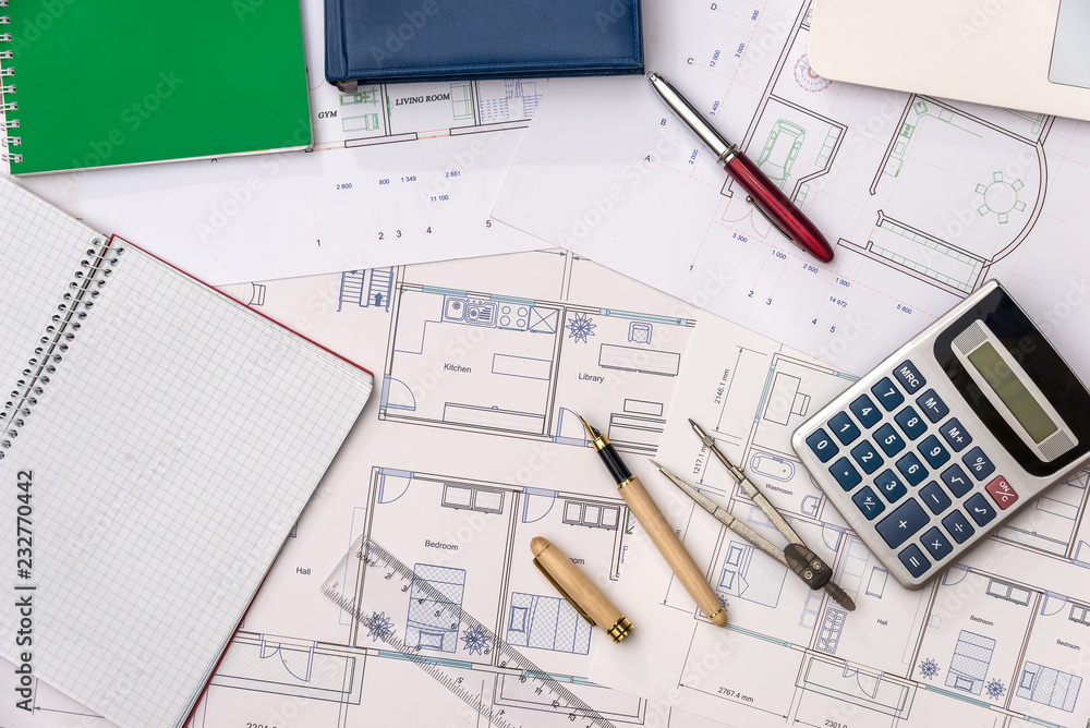 Top view of house plan with laptop, calculator and pencils Top view of house plan with laptop, calculator and pencils
