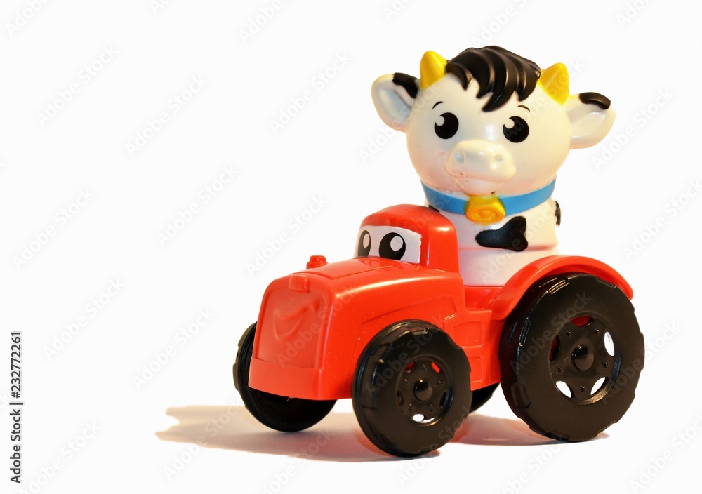 close up of a toy cow driving a truck on a white background close up of a toy cow driving a truck on a white background