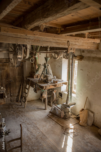 Traditional wooden flour mill equipment, viewed from side and other mill pully equipment, beamed celings very visible photo
