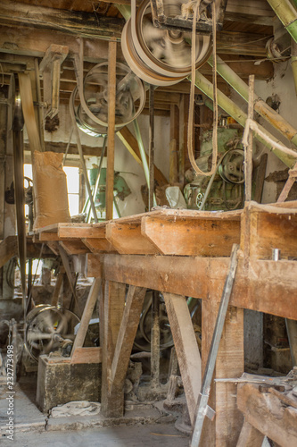 Traditional artisan wooden flour mill equipment, viewed from side and other mill pully equipment.