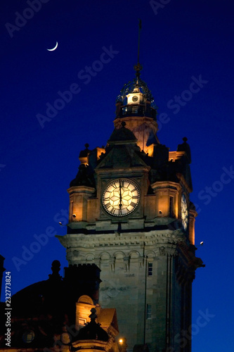 Balmoral Clock Tower at night with crescent moon , Edinburgh, Scotland
