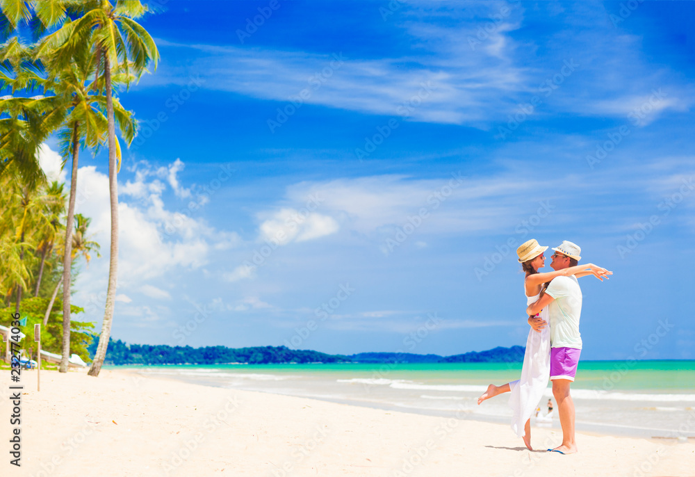 young couple on their honeymoon having fun by tropical beach young couple on their honeymoon having fun by tropical beach