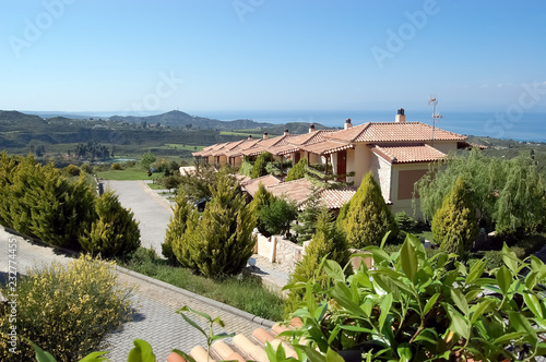 Panoramic views of the scenic mountainous terrain, the blue sea and the villas in Greece.