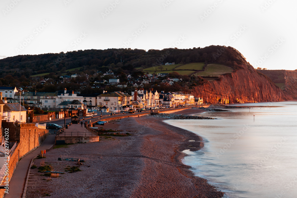 Warm early morning light on Sidmouth seafront and cliffs of Jurassic Coast, Devon,