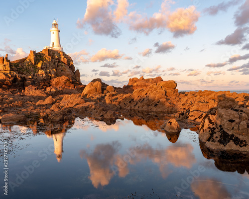 Coastal reflections at Corbiere, Jersey, Channel Islands lit by warm morning sun