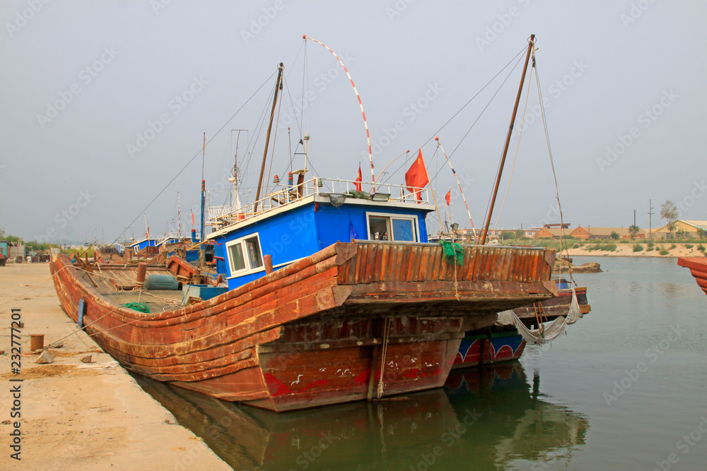 Fishing boats waiting in port wharf