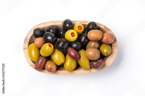  olives in a wooden bowl isolated against a white