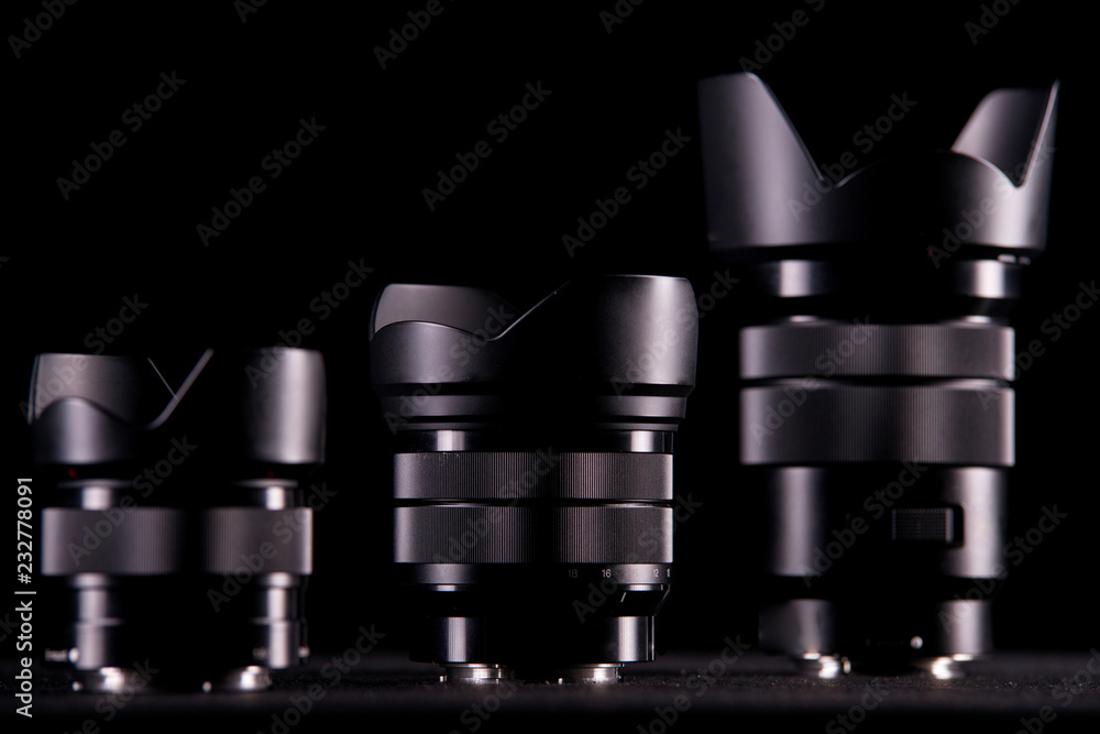 Three lenses for mirror less digital camera on a black background Three lenses for mirror less digital camera on a black background