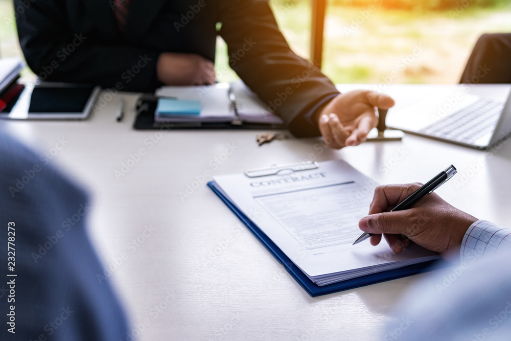 Business man is signing a contract for selling a new home. Concept home purchase contract. Business man is signing a contract for selling a new home. Concept home purchase contract.