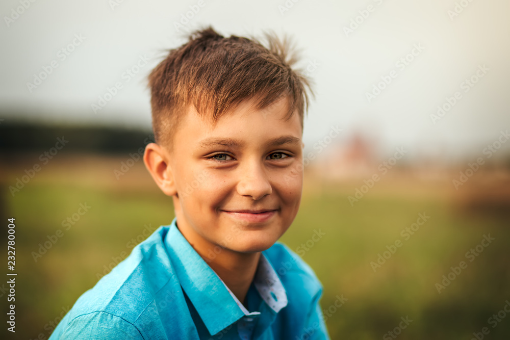portrait of a cute teen boy in summer in nature portrait of a cute teen boy in summer in nature