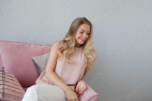 Young friendly woman sitting in a chair with a notebook in her hands. A nice companion.