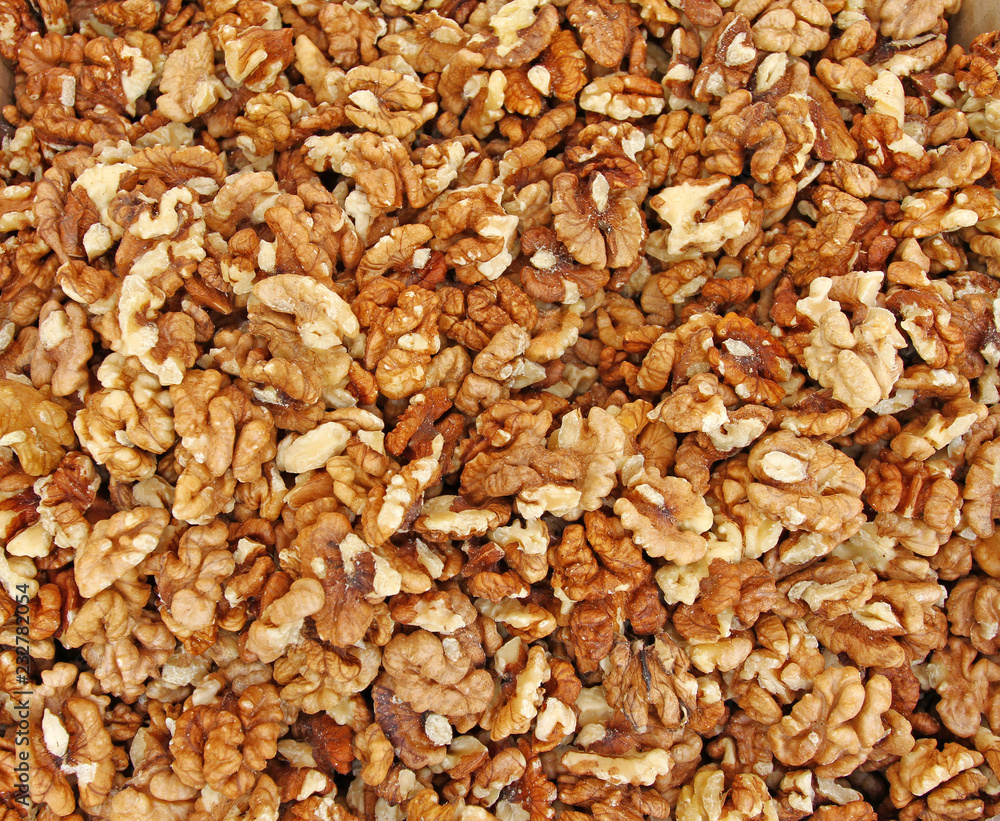 Full frame of peeled raw organic walnuts. Walnut background texture. Close up of nuts pattern. Walnuts wallpaper. Ripe and peeled walnut kernels. Full frame of peeled raw organic walnuts. Walnut background texture. Close up of nuts pattern. Walnuts wallpaper. Ripe and peeled walnut kernels.