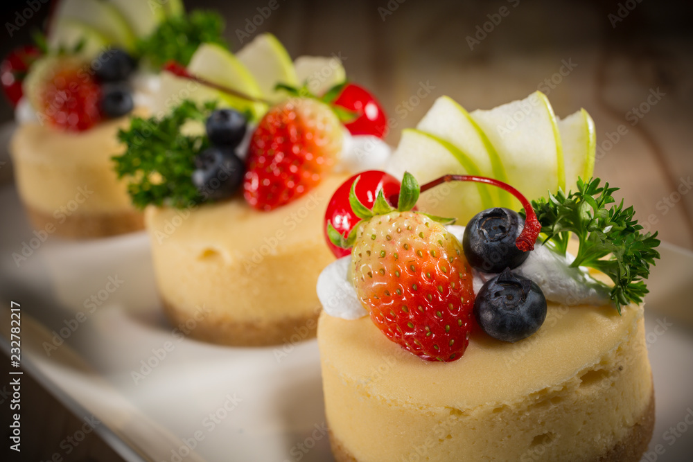 Cheesecake With Fruit Topping, Mixed fruit Cheesecake, Homemade cake on white dish, selective focus Cheesecake With Fruit Topping, Mixed fruit Cheesecake, Homemade cake on white dish, selective focus