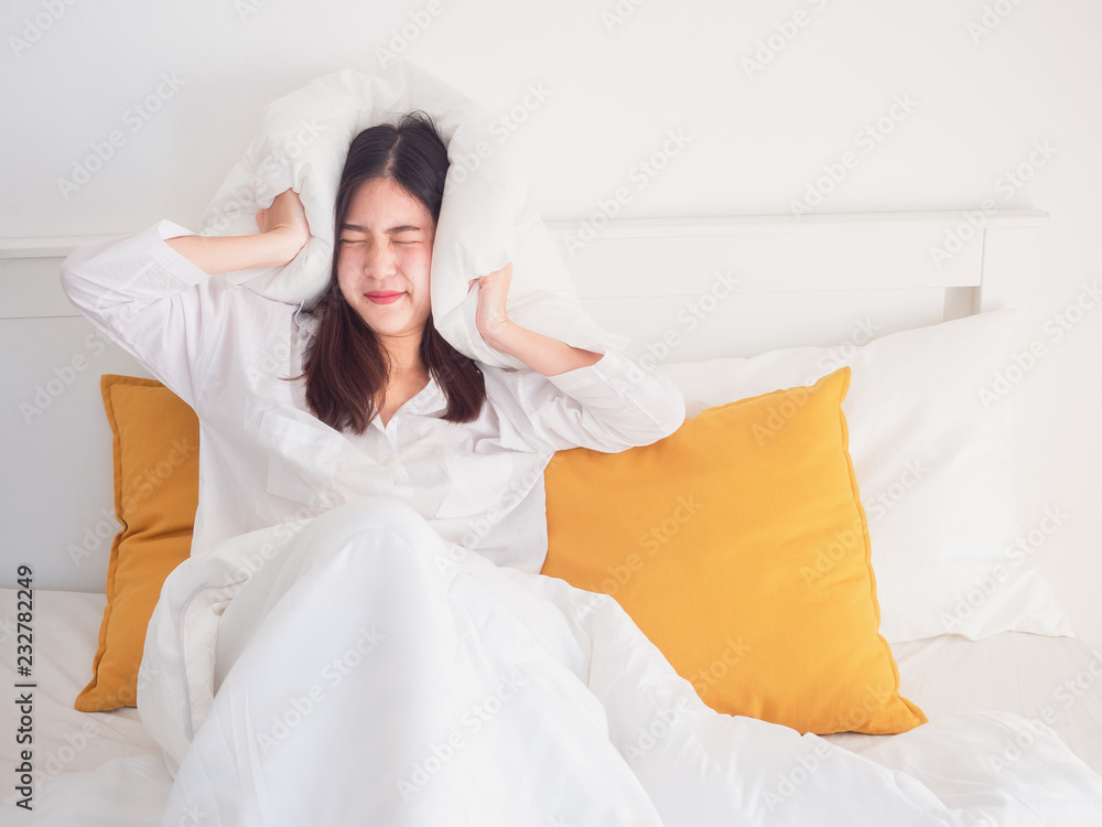 woman took the pillow off her ear after waking up woman took the pillow off her ear after waking up