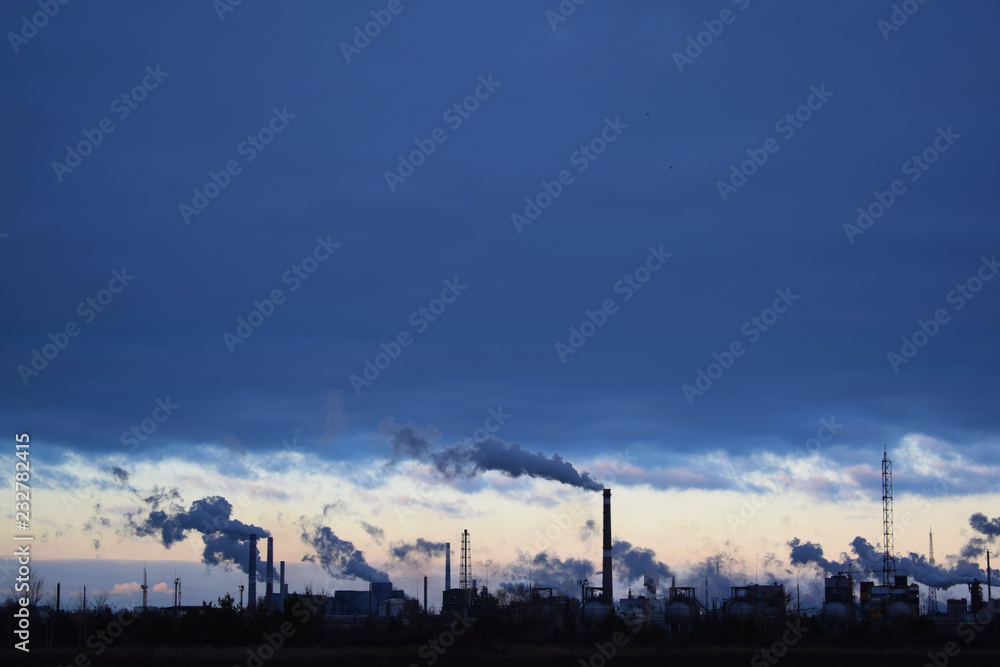 The plant emits smoke and smog from the pipes at sunset, pollutants enter the atmosphere. Environmental disaster. Harmful emissions into. Exhaust gases. Metallurgical industry against the sky.