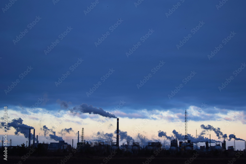 The plant emits smoke and smog from the pipes at sunset, pollutants enter the atmosphere. Environmental disaster. Harmful emissions into. Exhaust gases. Metallurgical industry against the sky.