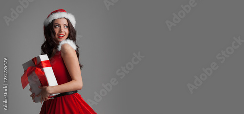 Woman in santa dress with gift