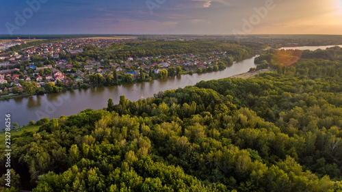 Aerial view of the summer city park near the lake. Beautiful view of nature.