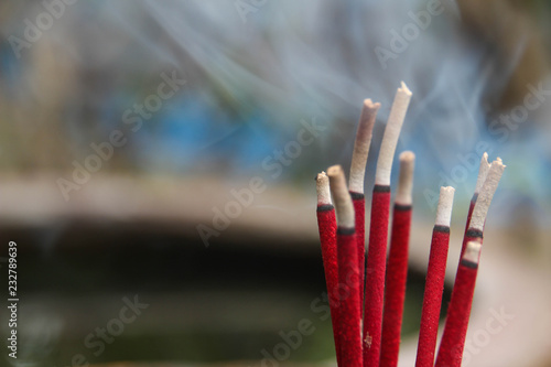 Red incense with white smoke.