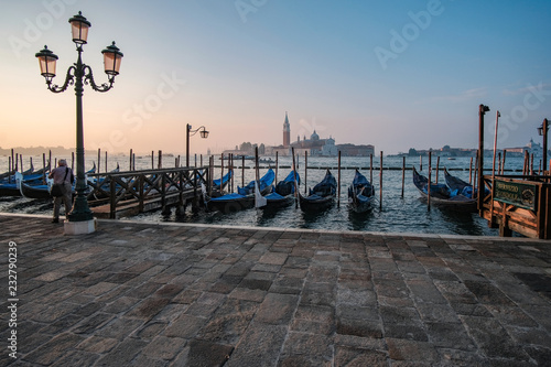 Venice, Italy, September 17, 2018 - Tourist take pictures sunrise on the waterfront next to the Doge Palace