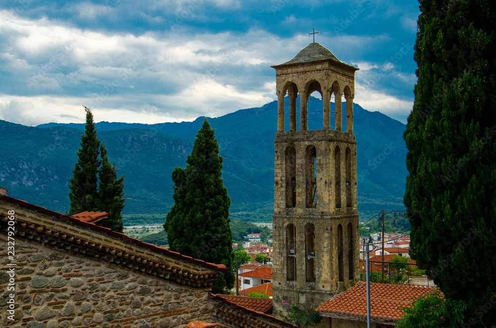 Bell tower in front of mountains in town Kalabaka, Greece