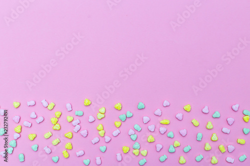 Multicolored candies on the pink background. Copy space © _nastassia