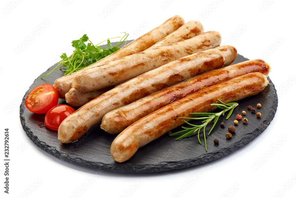 Grilled German White Thin sausages on a slate shale plate, isolated on a white background. Close-up.