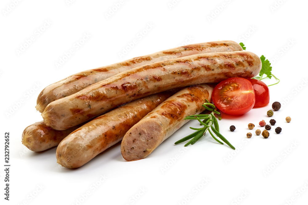 Grilled Nuremberg Sausages with herbs, pepper and tomatoes, isolated on a white background. Close-up.