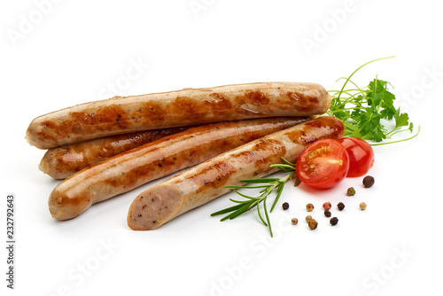 Grilled German White Thin sausages with herbs, pepper and tomatoes, isolated on a white background. Close-up.