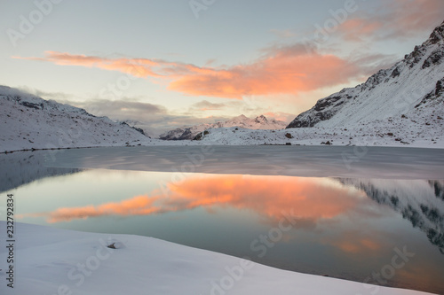 Maurigno lake at sunset during spring. Verva pass, Valdidentro, Lombardy, Italy.