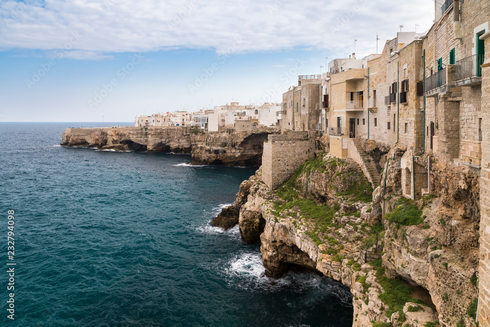 View of the overhanging houses and caves of Polignano a Mare. Bari district, Apulia, Italy, Europe. View of the overhanging houses and caves of Polignano a Mare. Bari district, Apulia, Italy, Europe.