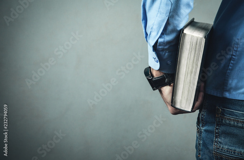 Caucasian man holding bible.